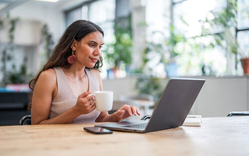 Confident Young Aboriginal Businesswoman Engaged on Laptop