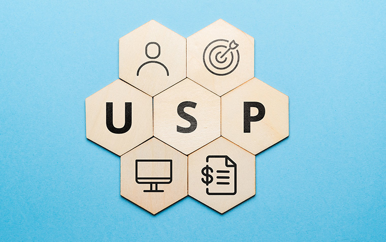 cronym USP or Unique Selling Proposition. Abstract icons and text on wooden forms