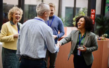 Business people greet each other at a conference